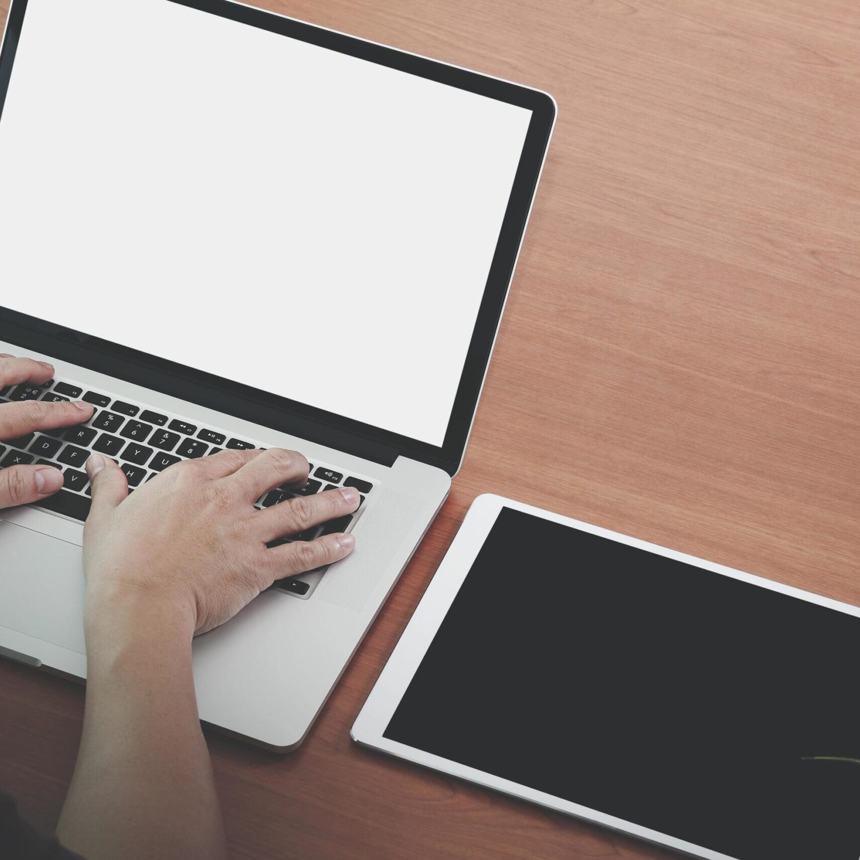 businessman-hand-working-with-new-modern-computer-laptop-and-pro-digital-tablet-on-wooden-desk-as-concept-free-photo